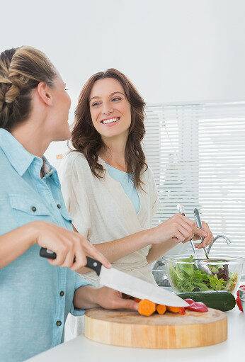 pretty-women-preparing-salad-together